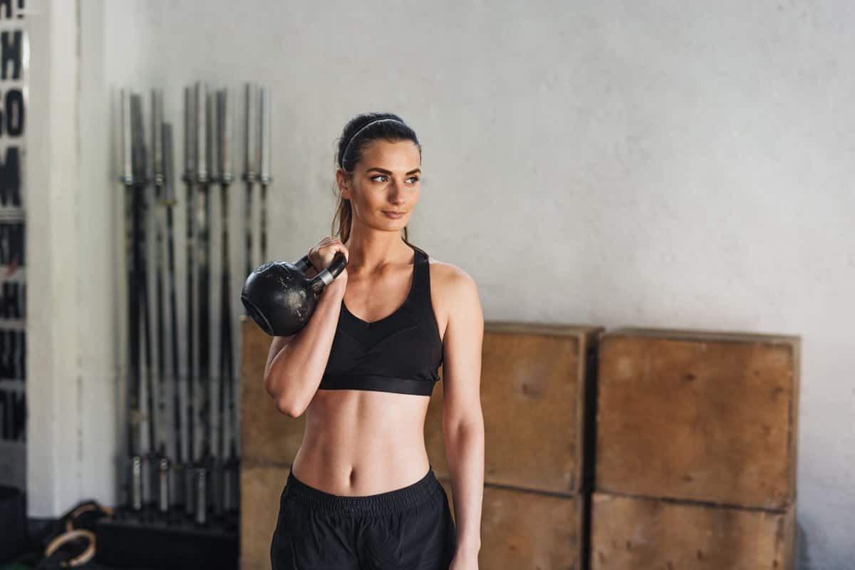 attractive woman holding a kettlebell