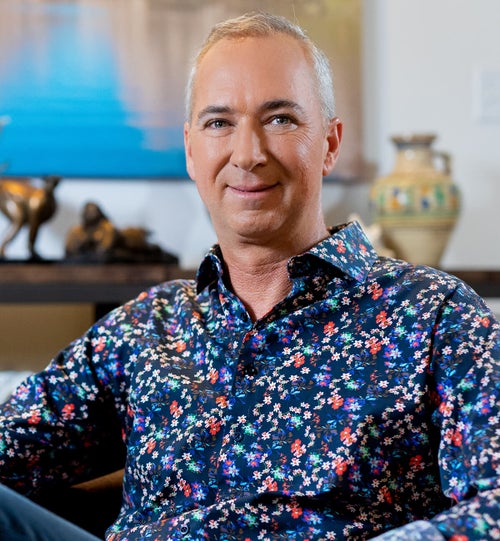 Portrait shot Cameron Herold wearing a floral shirt