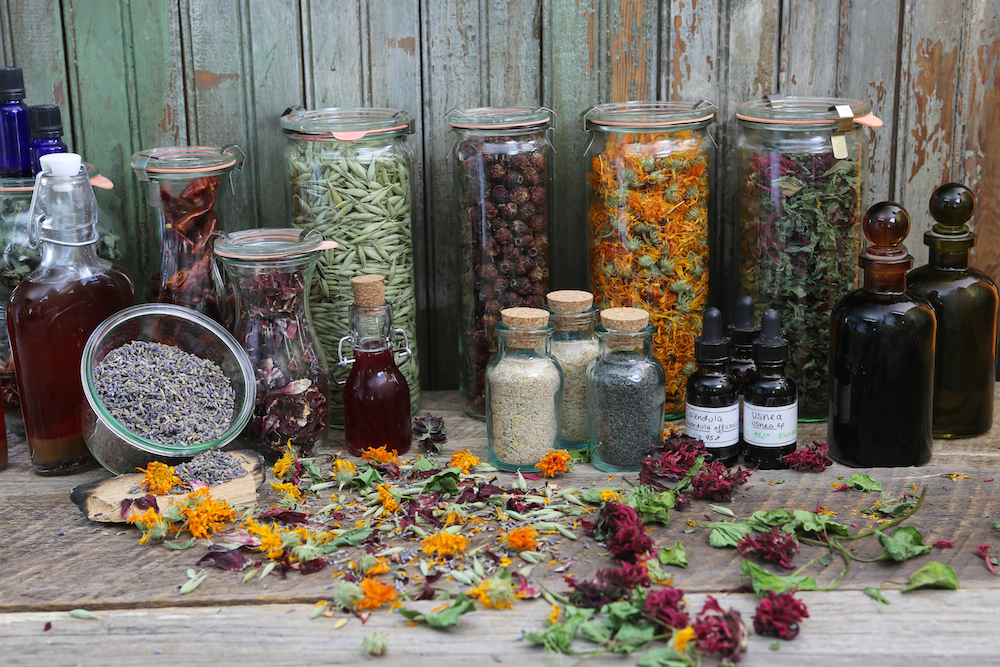 Jars of colorful dried herbs.