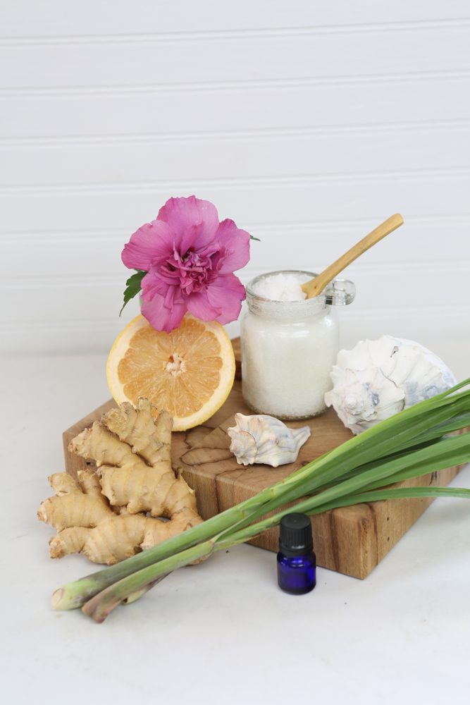 A jar of salt scrub and its ingredients.